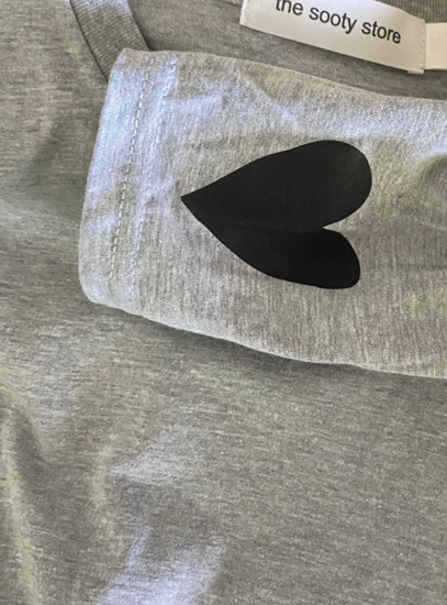 Grey marle long sleeve tee shirt with black heart on the sleeve. 